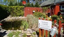 Bungalow Leonie mit schönem Garten inklusive kleinem Teich mit Fischen