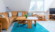 Wohnzimmer Couch, TV und Zugang zum Balkon